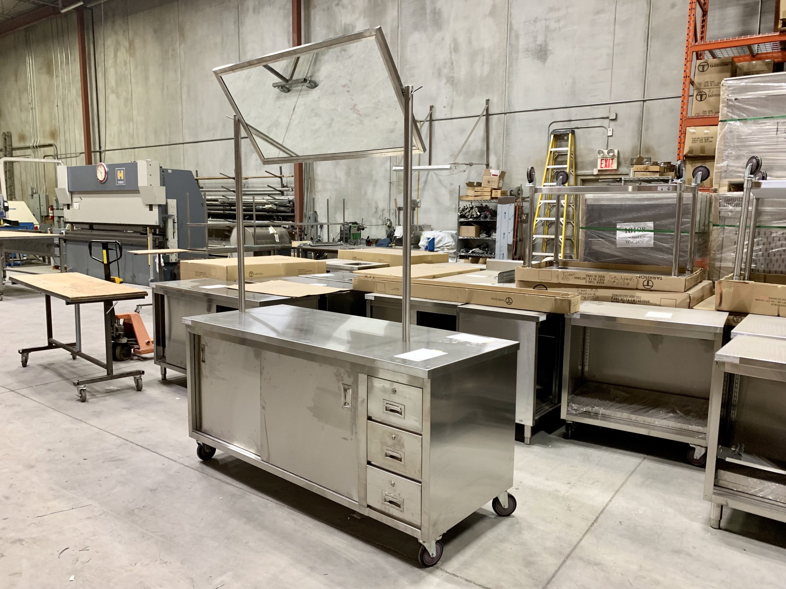 Demo station with overhead mirror in a stainless steel fabrication workshop